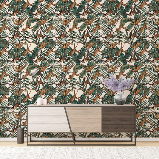 Monkeys on Creepers Green Tropical Leaves Wallpaper behind a wooden sideboard.