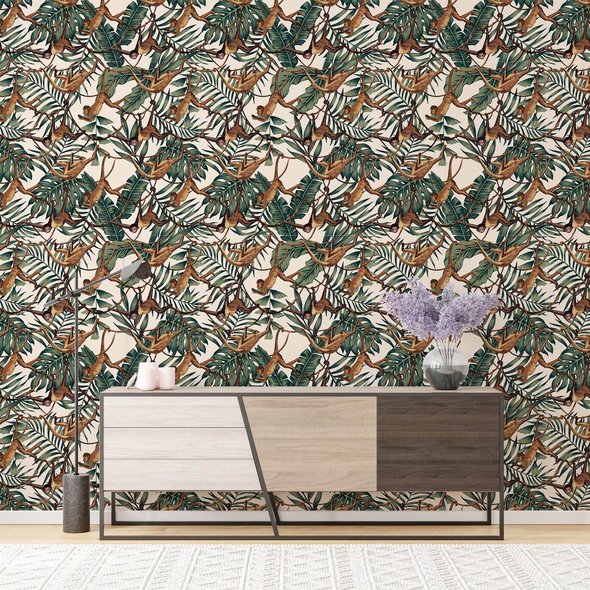 Monkeys on Creepers Green Tropical Leaves Wallpaper behind a wooden sideboard.