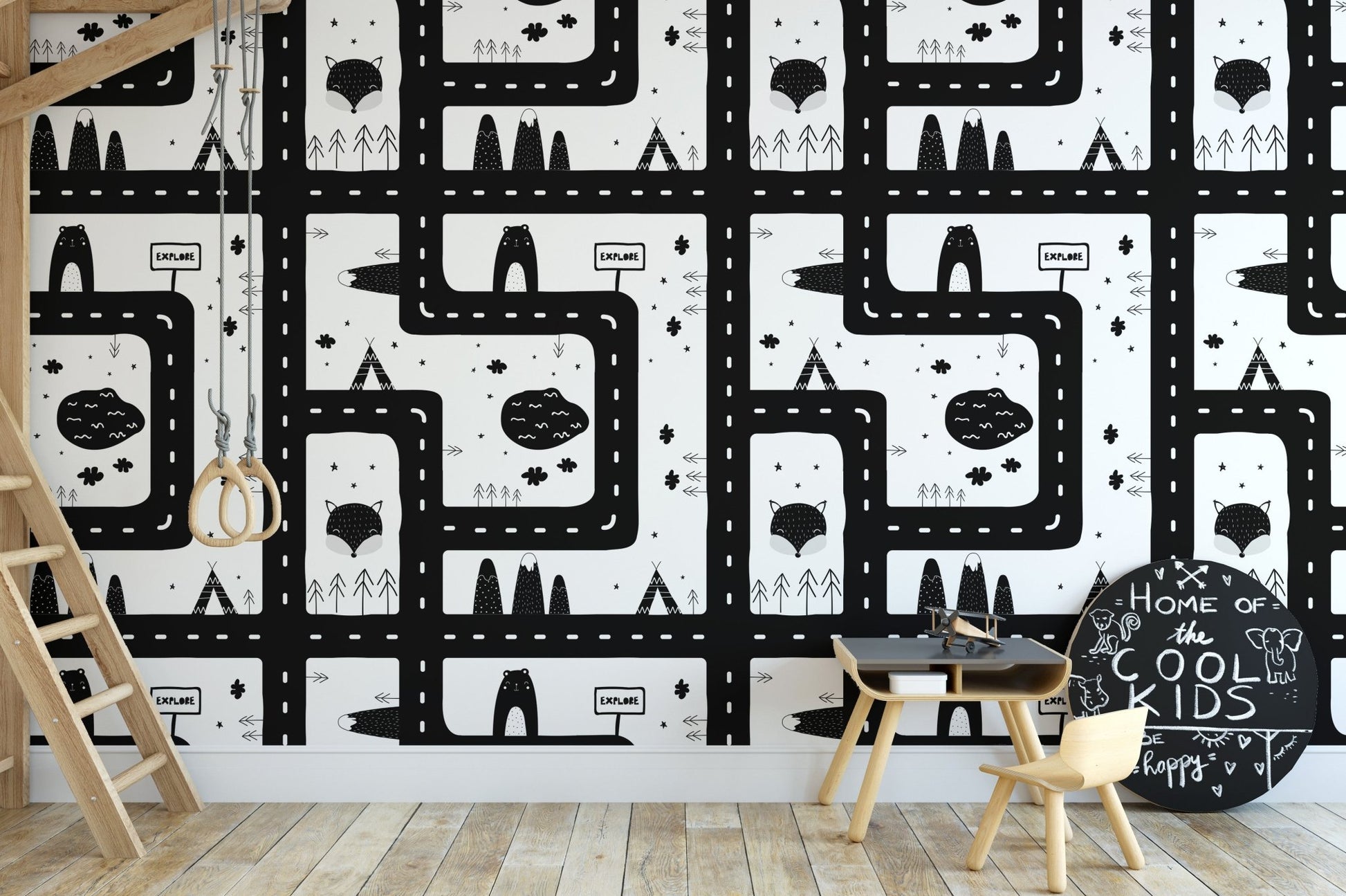 Black and white cityscape wallpaper in a study room with wooden chair and table.