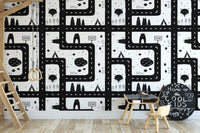 Black and white cityscape wallpaper in a study room with wooden chair and table.