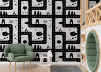 High contrast cityscape road map wallpaper behind a green armchair in a nursery