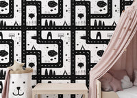Monochromatic city map wallpaper next to a pink canopy bed.