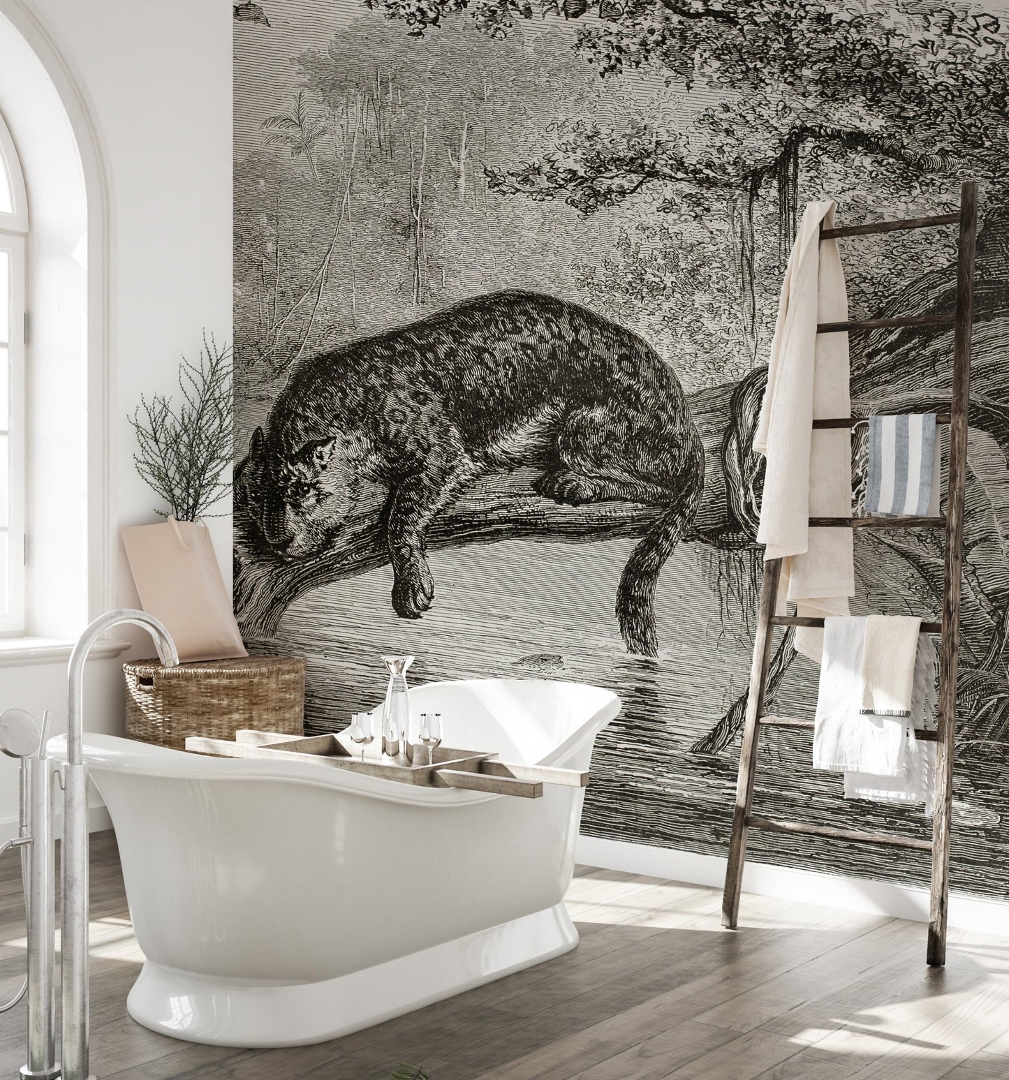 Large scale leopard wall mural in a bright bathroom with a classic white tub.
