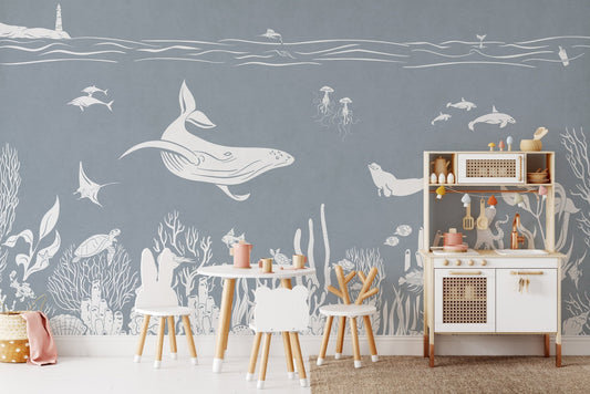 Ocean illustration blue wall mural wallpaper with whales and coral patterns.