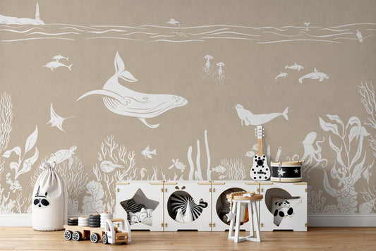 Ocean-inspired brown wallpaper mural featuring whales, fish, and coral artwork.