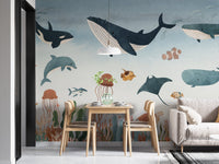 Underwater creatures wall mural behind a wooden dining table and chairs.