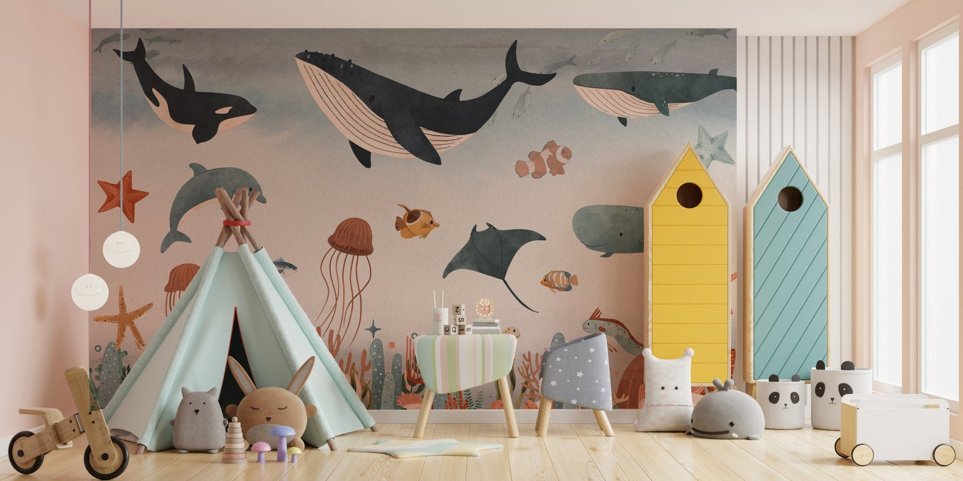 Whales and dolphins monochrome wall mural in a playroom with a teepee and toys.
