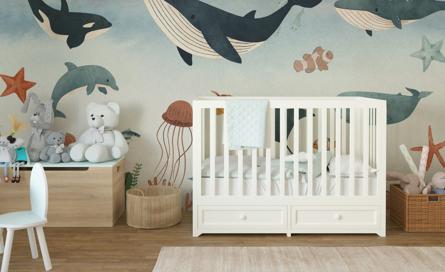 Blue underwater wall mural installed behind a white wooden baby crib in toddler room.