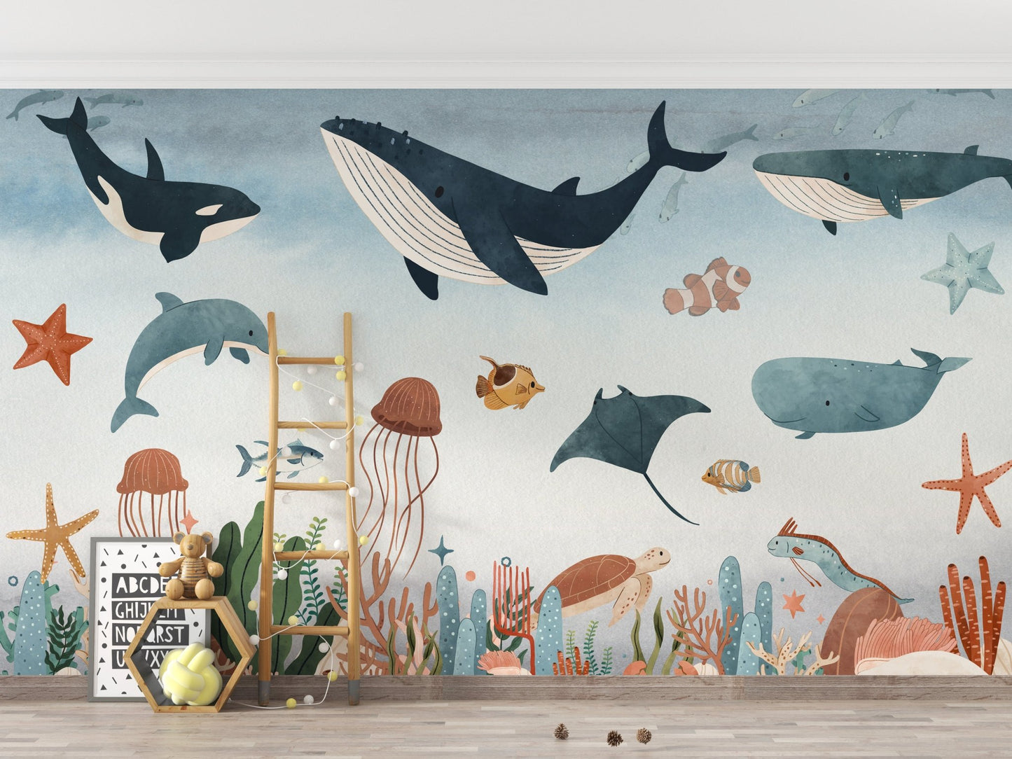 Blue and grey underwater wall mural in a kids room with a wooden ladder.