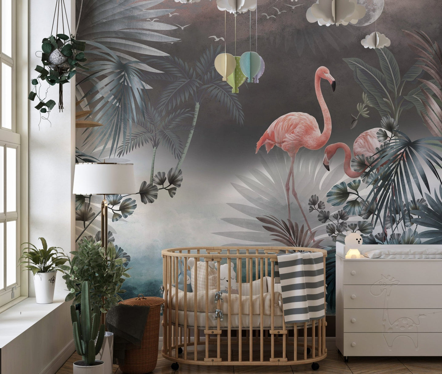 Monstera leaves wall mural featuring pink flamingos in a nursery setting.