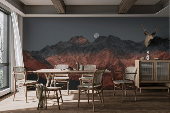 Moon over mountain wallpaper with a full moon rising behind dark jagged peaks.