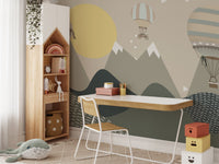 Child's study area with a adventure themed wall mural and wooden desk.