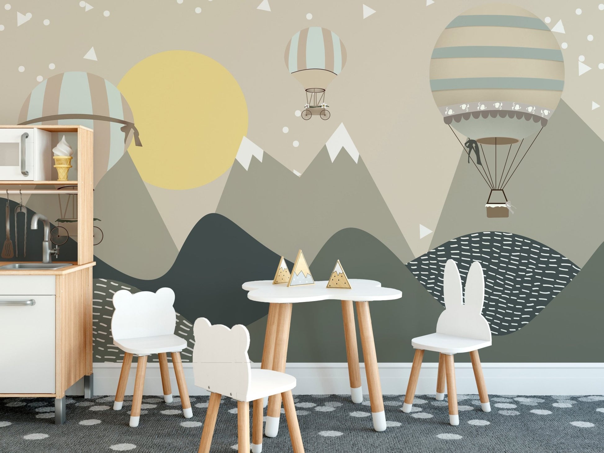 Dining room with a grey mountain wall mural and white furniture for toddlers.