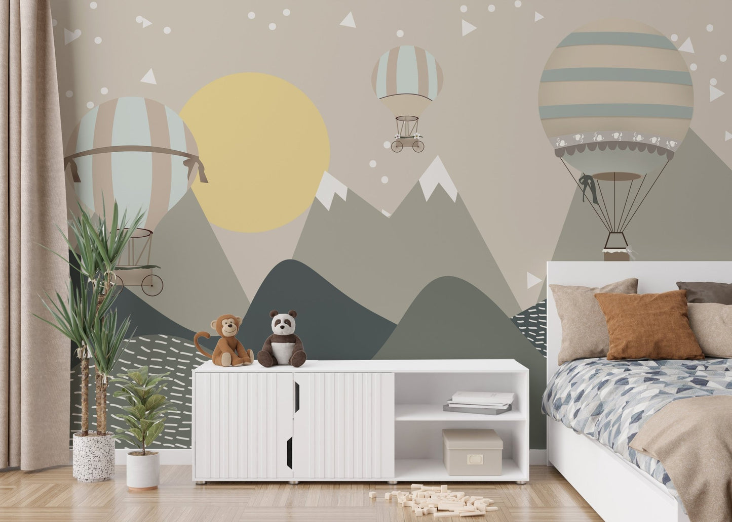 Kids' bedroom with a mountain and hot air balloon wall mural in grey and yellow.
