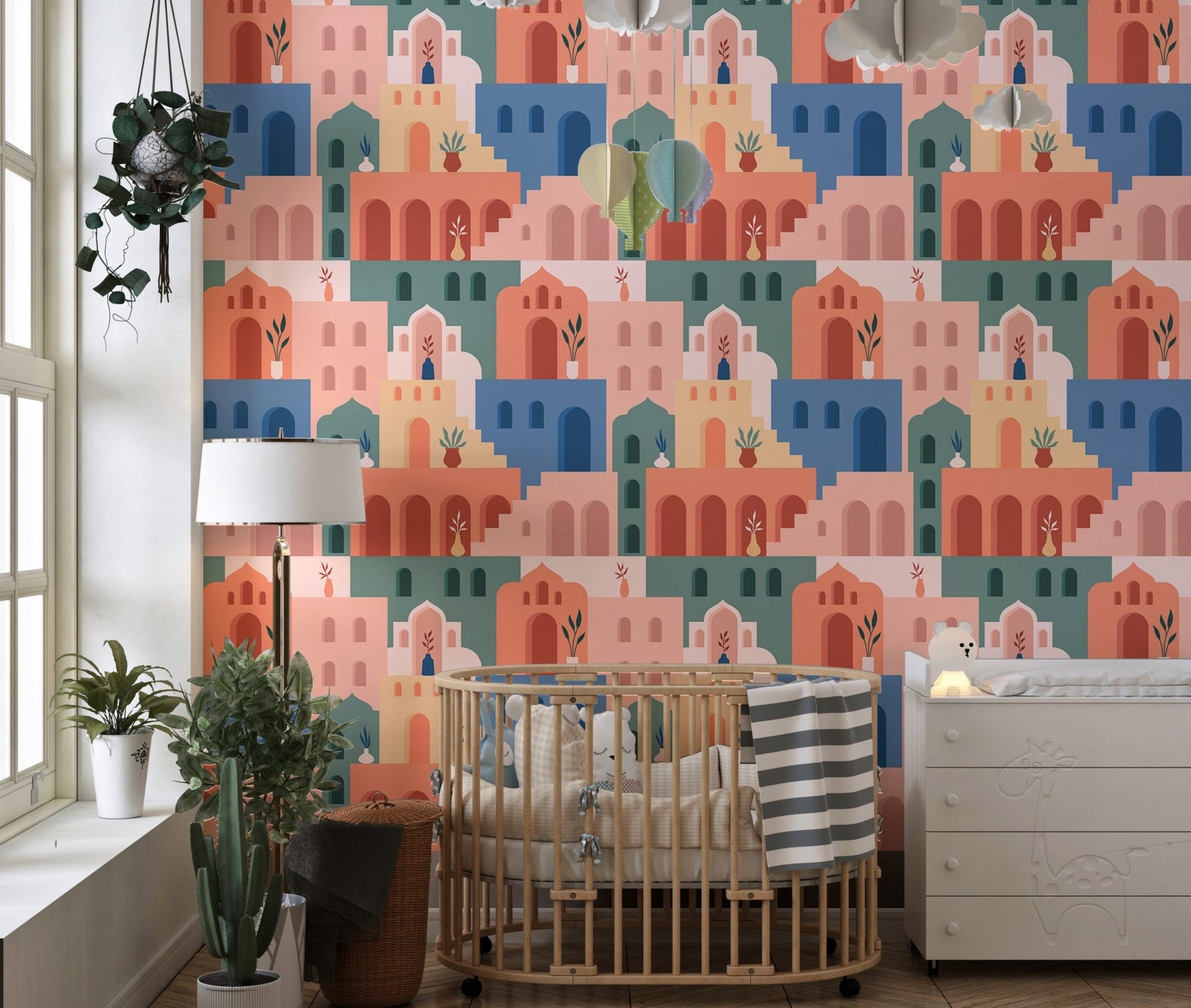 Bohemian wallpaper with terracotta and blue houses in a minimalist nursery.