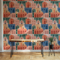 Colorful building wallpaper behind a wooden desk and black metal legs.