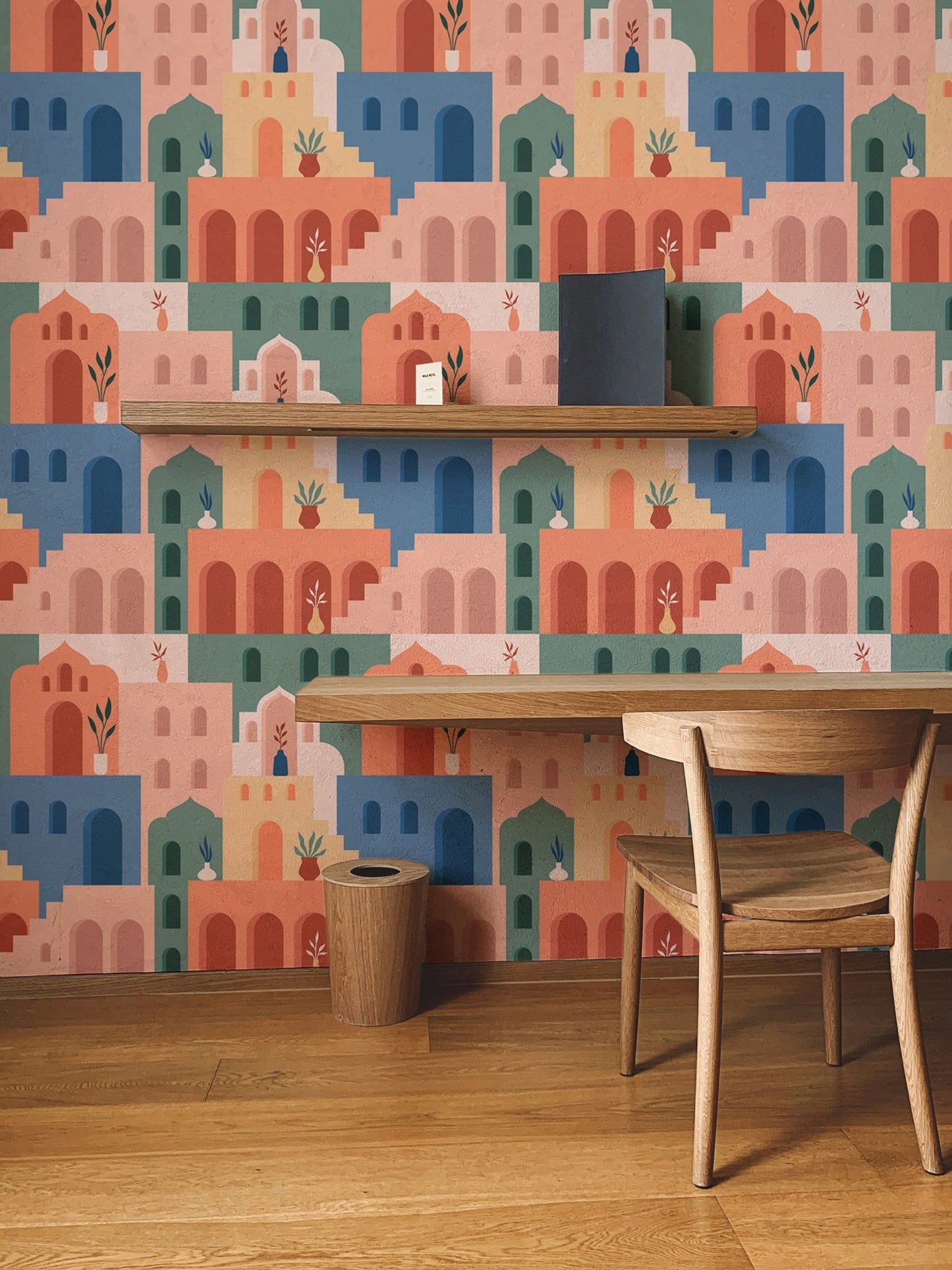 Moroccan Oriental Streets wallpaper decorating a wall with a wooden study desk.