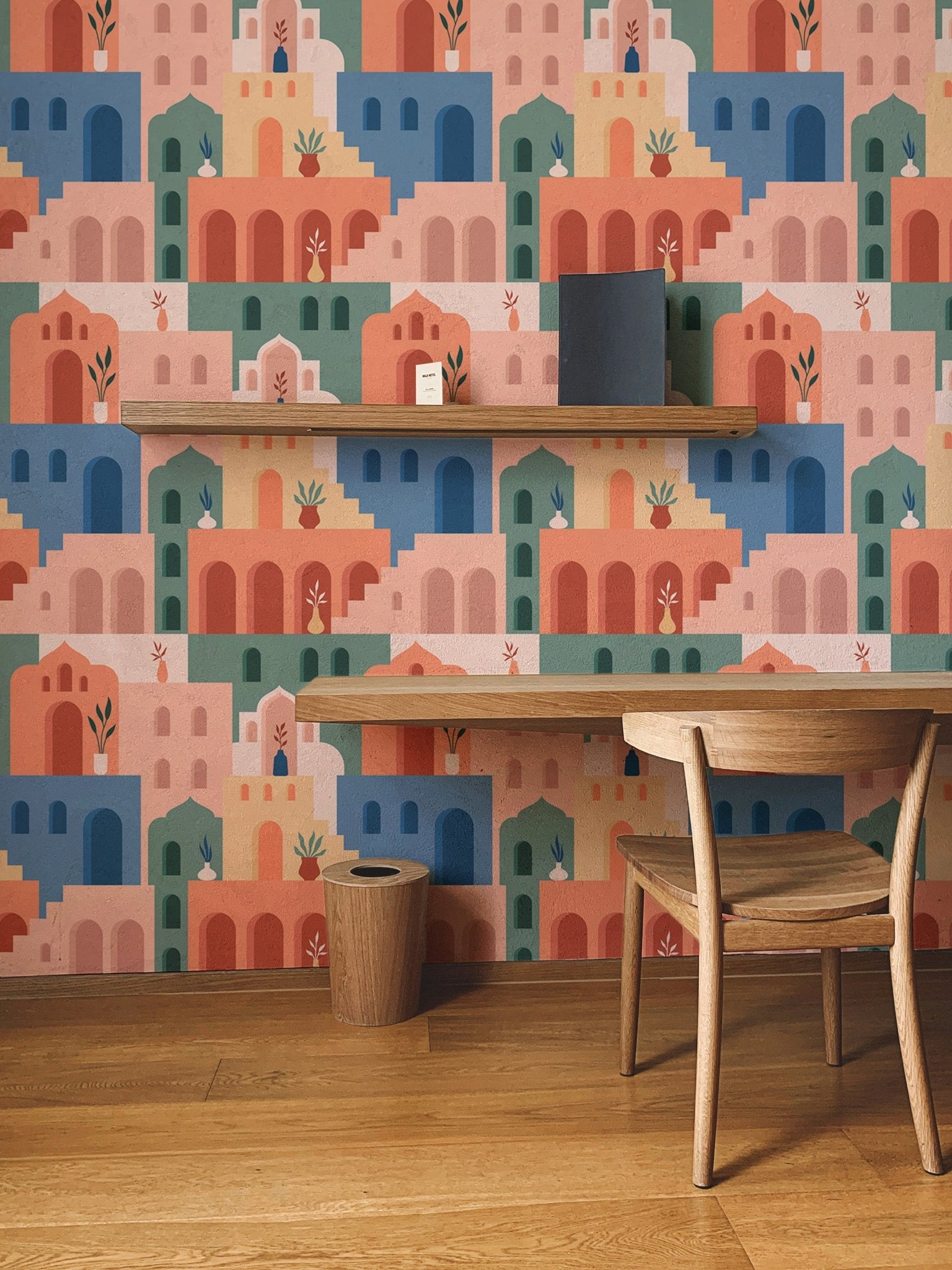 Moroccan Oriental Streets wallpaper decorating a wall with a wooden study desk.