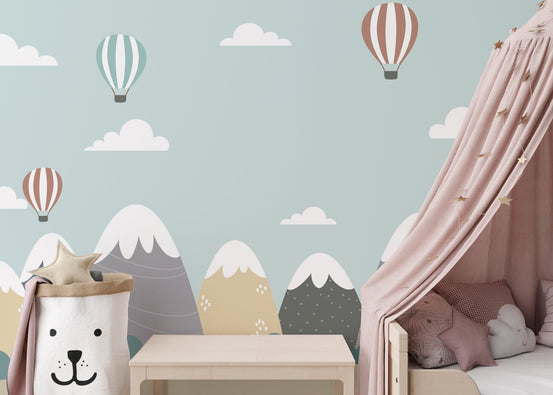 Mountain and Hot Air Balloons wall mural in a pastel blue bedroom with a pink canopy.