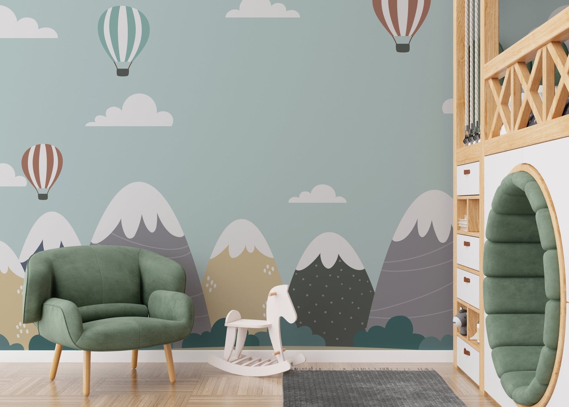 Playroom with a green armchair and mountain and hot air balloons wall mural.