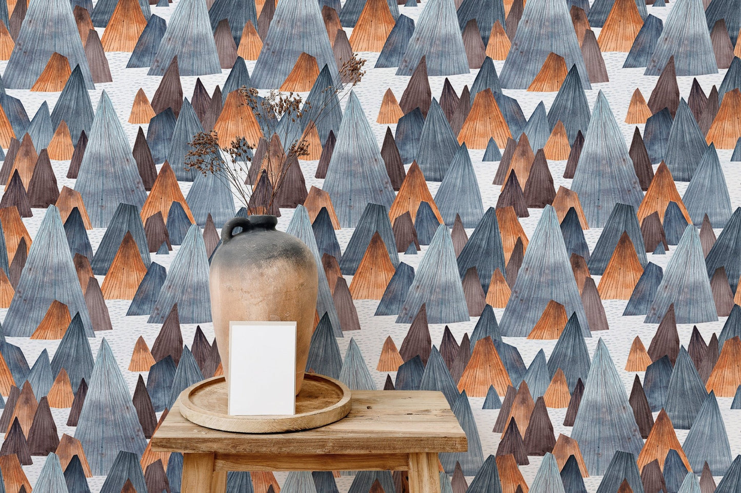 Grey and orange mountain wallpaper on small shelf display area.