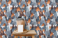Grey and orange mountain wallpaper on small shelf display area.