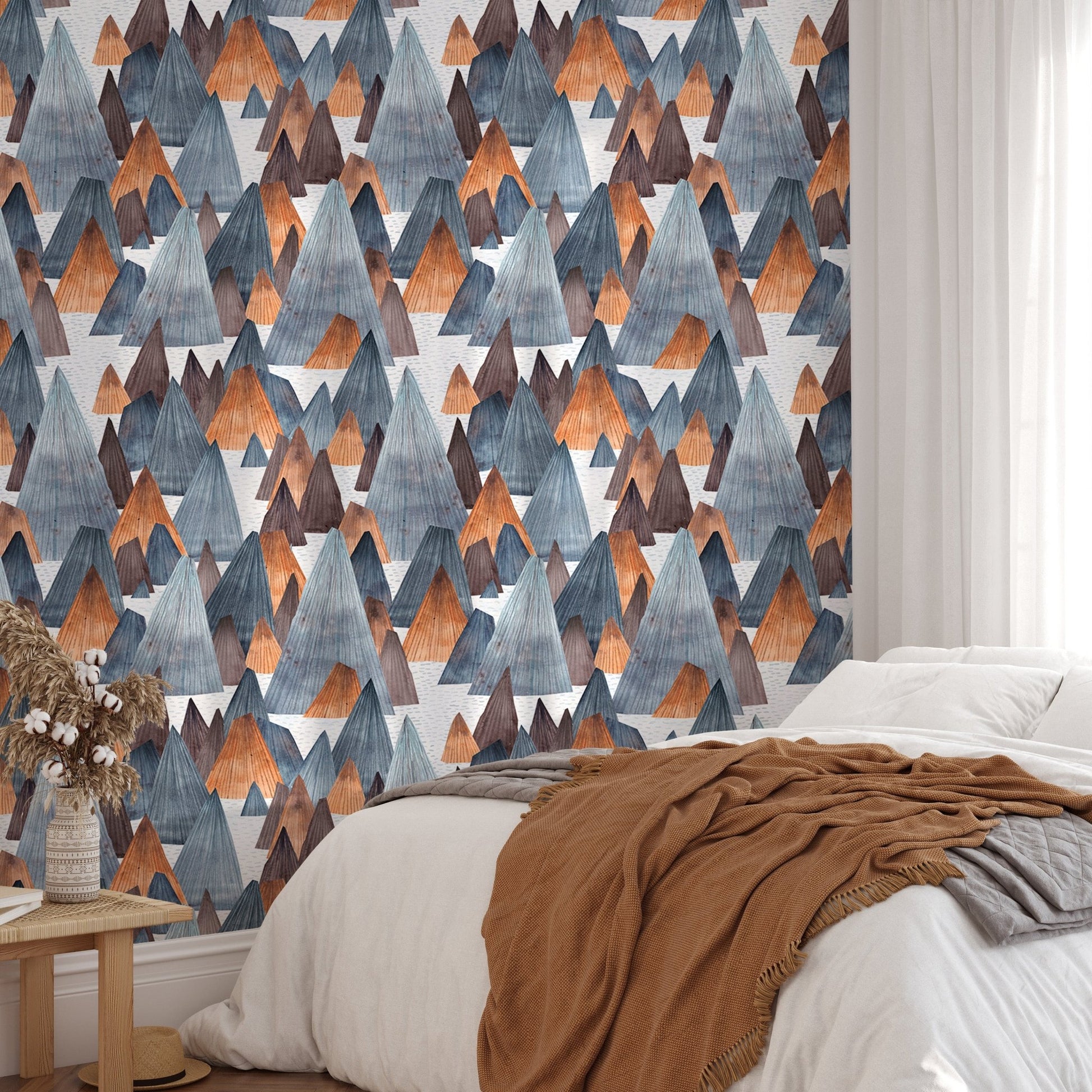 Textured mountain wallpaper in bedroom with terracotta accent pillows.