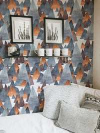 Minimalist mountain wallpaper with black frames and white bedding.