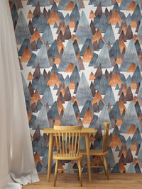 Geometric mountain landscape wallpaper in dining area with wooden table.