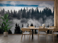 Minimalist dining area with wooden table and misty woodland wall mural.