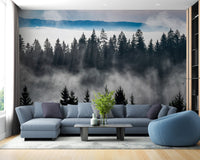 Blue sectional sofa against a mountain pine tree wall mural in a bright room.
