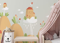 Kids room mountain wall mural paired with a pink canopy bed and bear pillow.