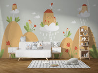 Nursery wall mural featuring orange mountain, clouds, and small houses.