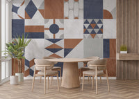Round dining table set against an art deco patterned wall mural.