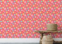 Pink and blue circle wallpaper used as a backdrop for a wooden bench.