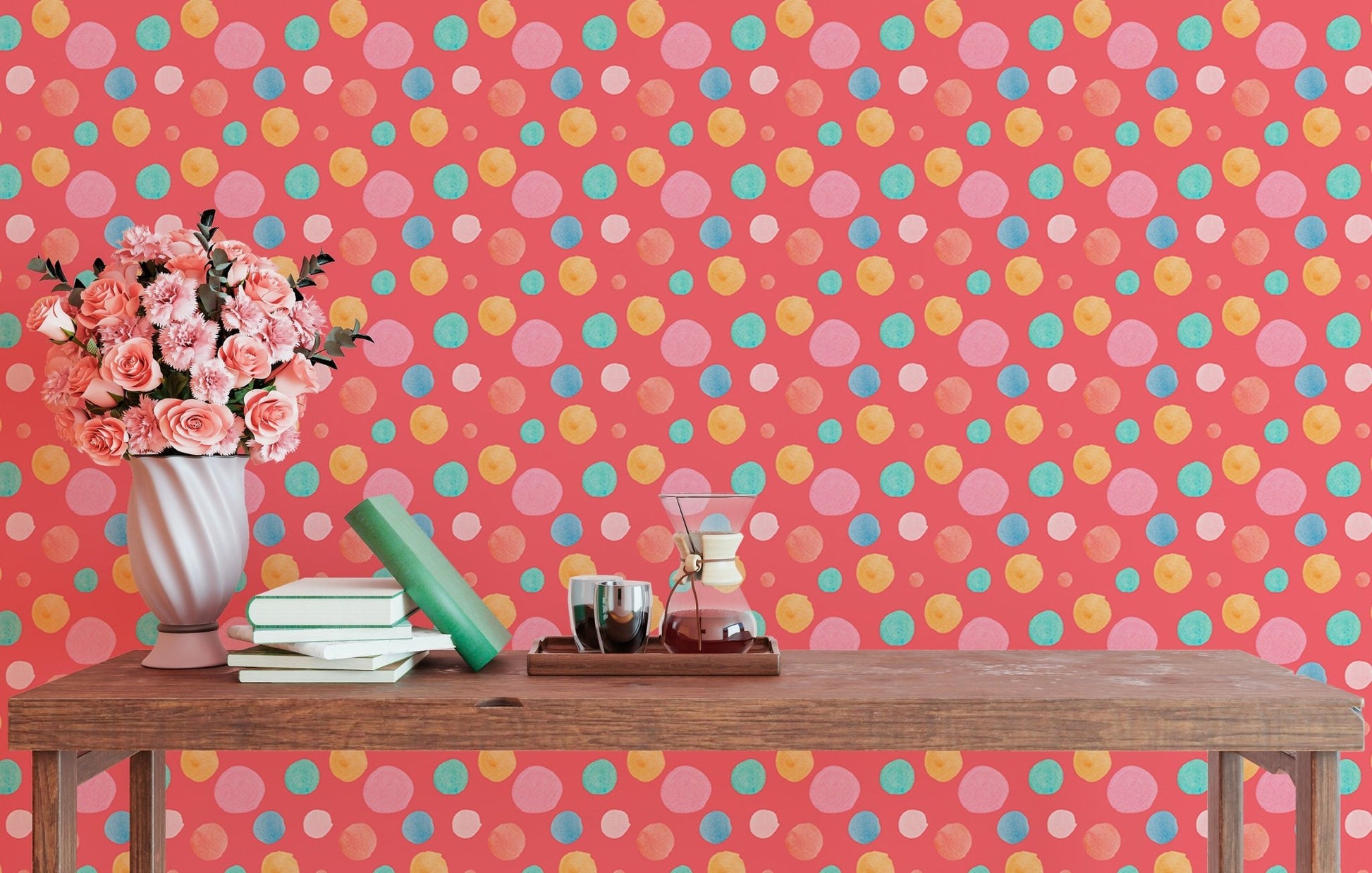 Abstract circle wallpaper mural behind a desk with pink flowers and books.