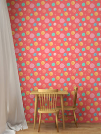 Circular pattern wallpaper in a small dining area with wooden chairs.