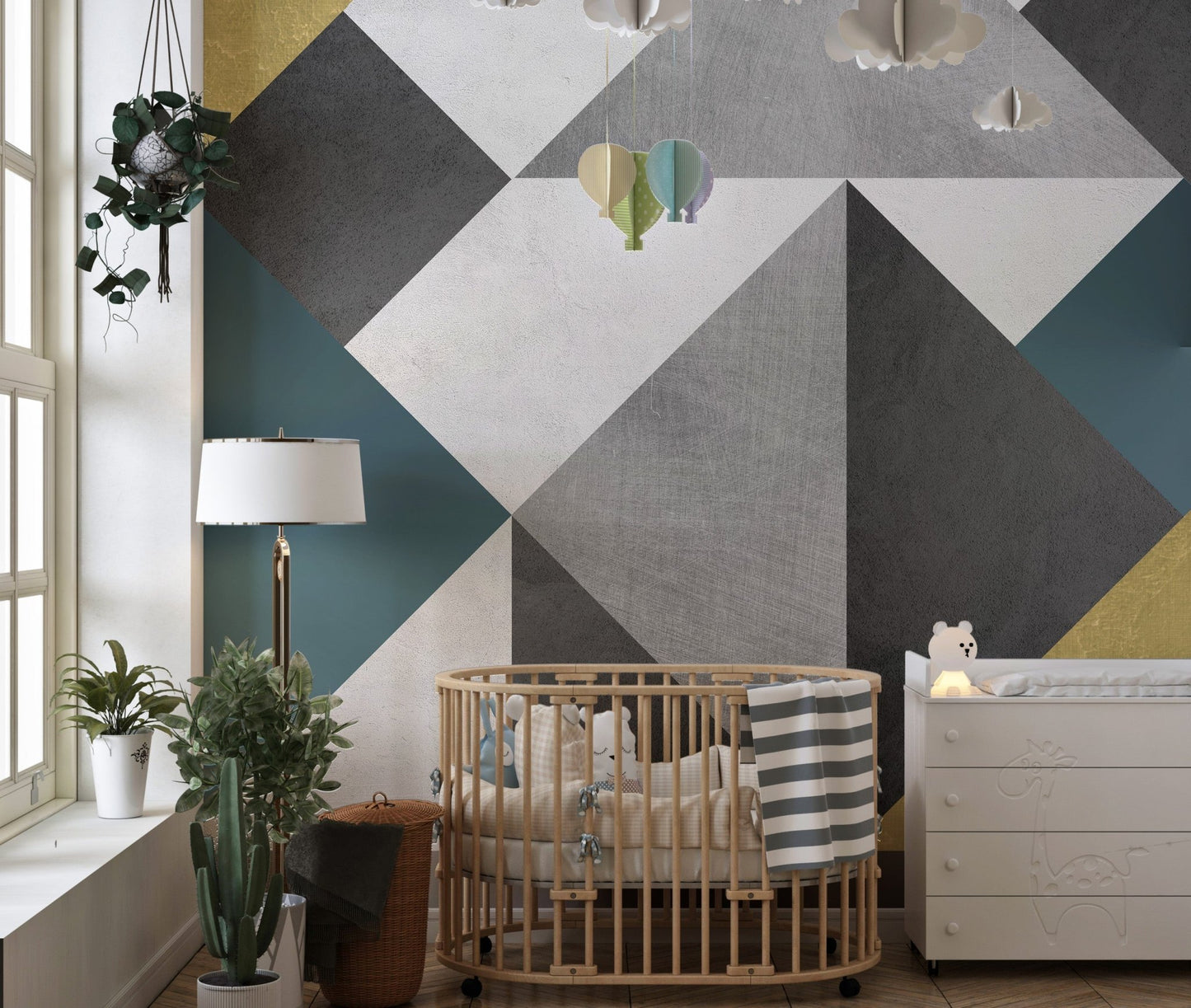 Modern triangle wall mural in a nursery with a wooden cot.
