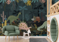 Green armchair placed in front of a dark jungle dinosaur wall mural.