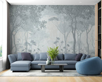 Tranquil fog forest wall mural behind a blue sofa in a modern flat.