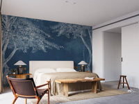 Dark blue indigo forest wall mural in a master bedroom with a wooden bench.