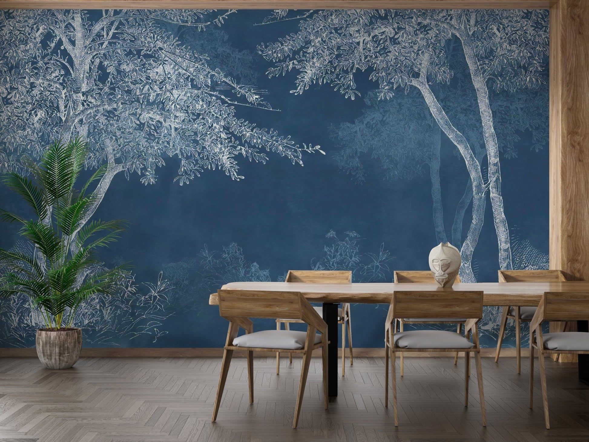 Indigo tree mural wallpaper in a dining room with a light wood table and chairs.