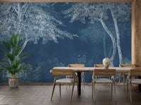 Indigo tree mural wallpaper in a dining room with a light wood table and chairs.