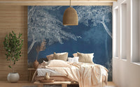 Mystical Indigo Wilderness Wall Mural behind a bed with a wooden headboard.


