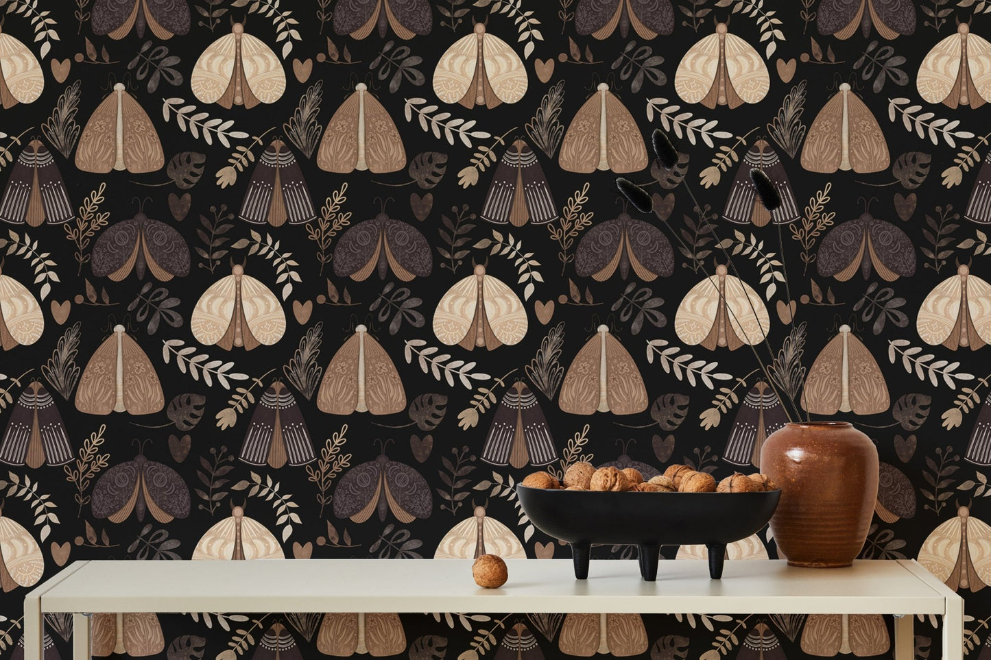 Symmetrical moth wallpaper on a dining room wall with white table and vases.