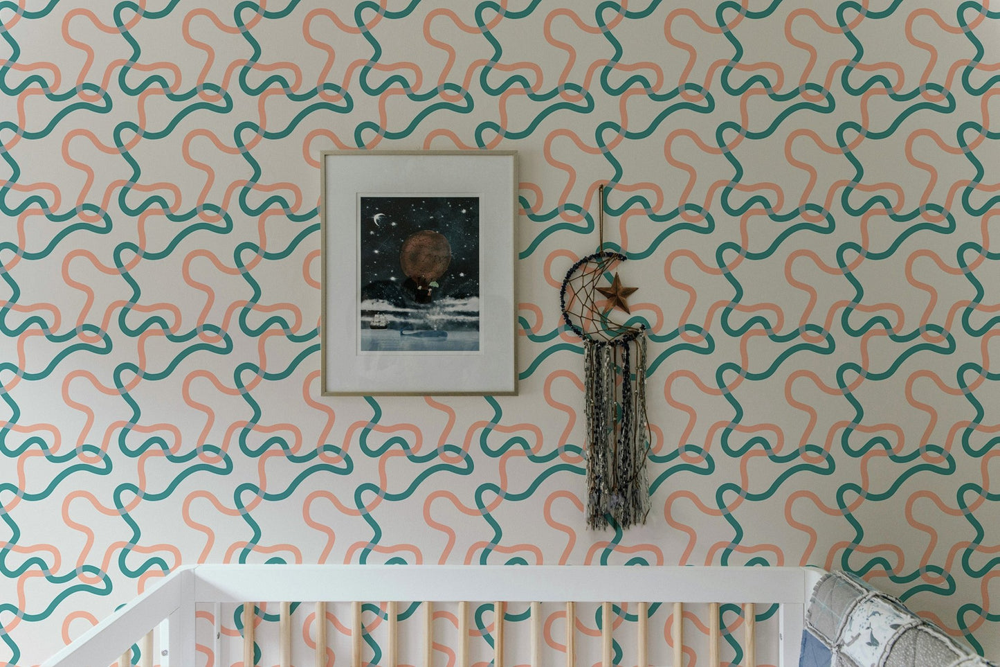 Nursery wall decor featuring teal and peach abstract lines wallpaper patterns.