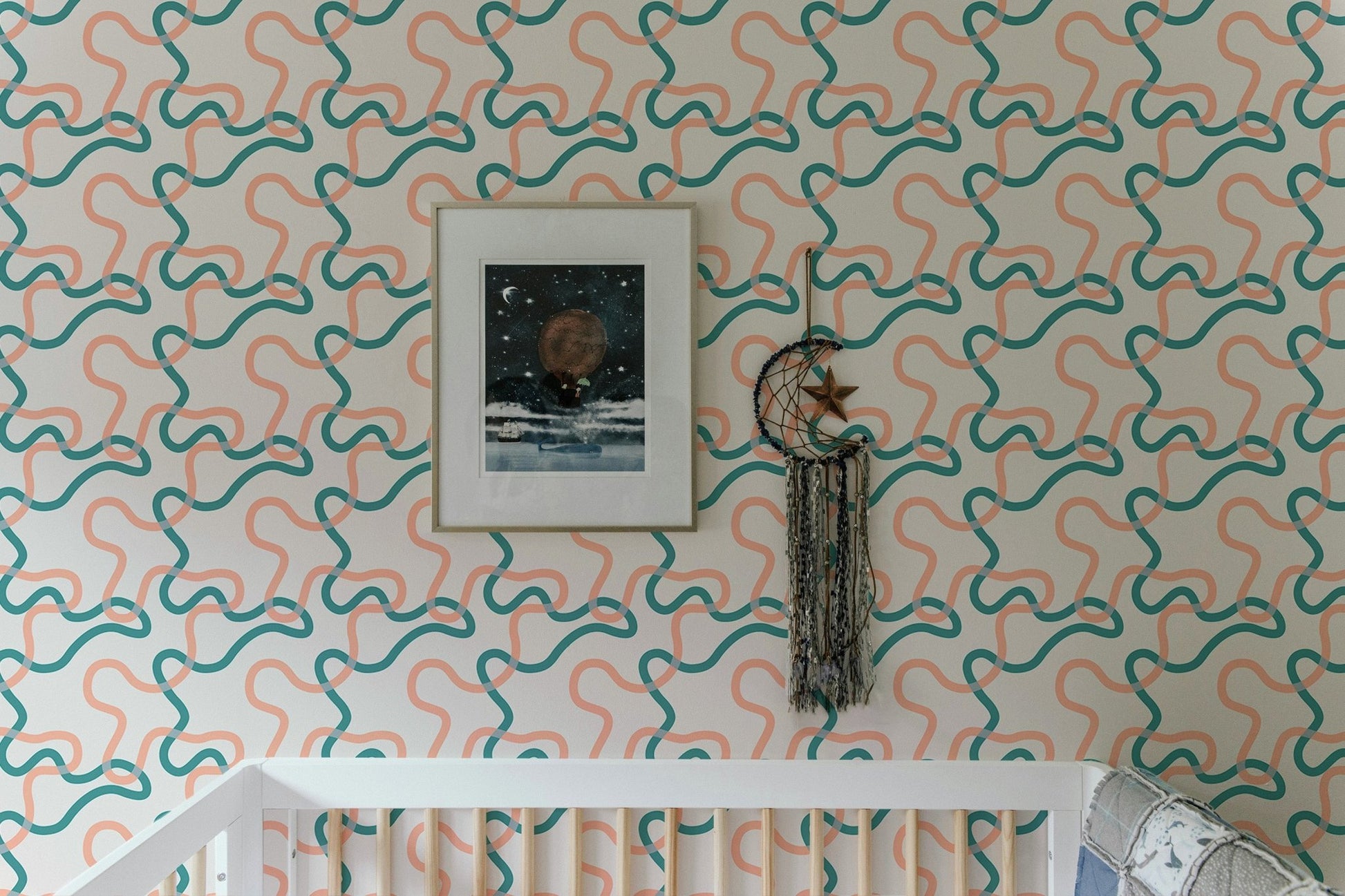Nursery wall decor featuring teal and peach abstract lines wallpaper patterns.
