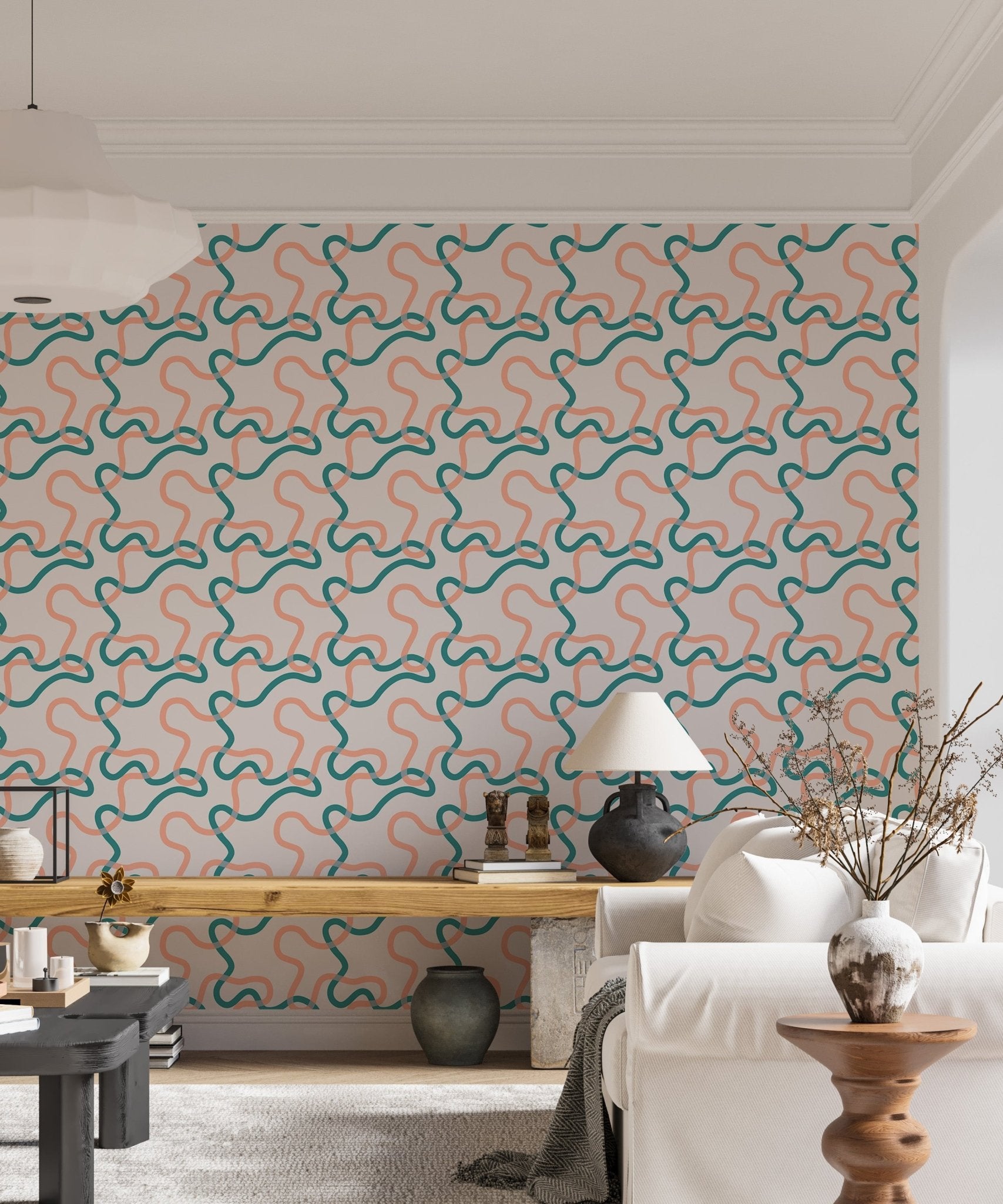 Wallpaper with teal and peach line squiggles behind a white sideboard and indoor plants.