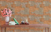 Orange stone pavement wallpaper behind a wooden table with pink flowers