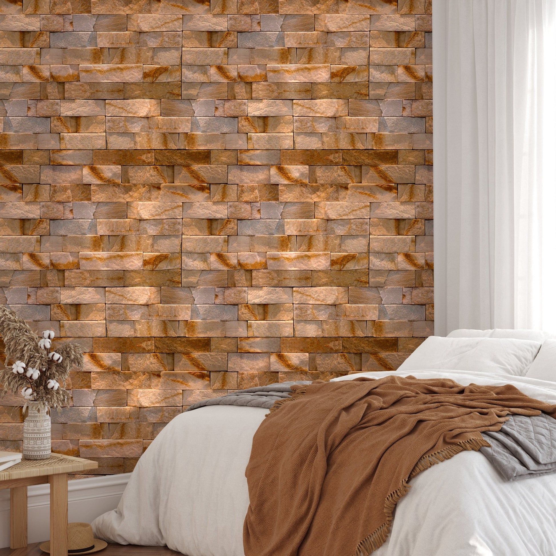 Brown stone wallpaper in bedroom behind a bed with neutral linens and wooden furniture.